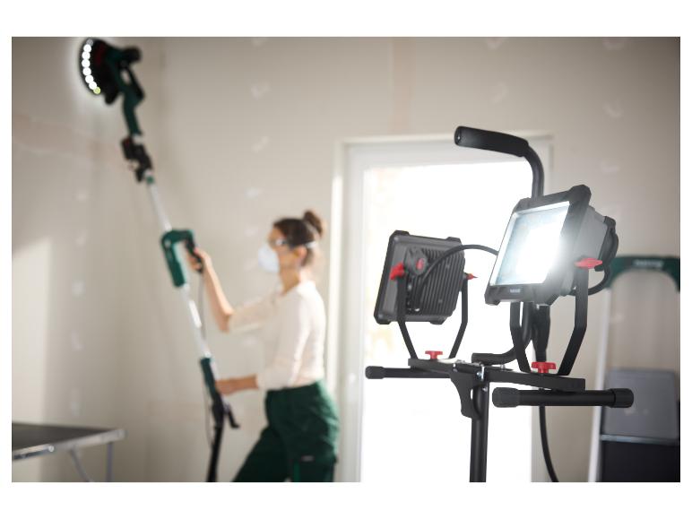 Mise au point sur les éclairages de travail Einhell et la ponceuse murale dans un atelier.