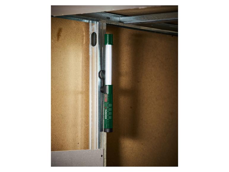 Lampe de travail fixée à un profil métallique sur un chantier