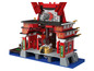 Un bâtiment rouge en Lego avec un motif de dragon, construit sur des tuiles d'eau bleues.