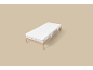 Cadre de lit en bois simple avec matelas blanc sur fond beige.