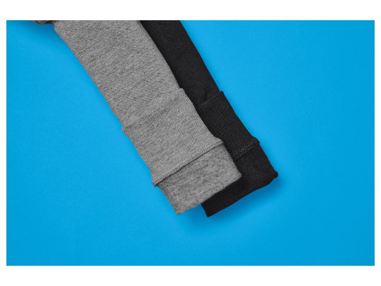 Deux manches de pull, une grise et une noire, sur fond bleu.