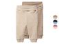 Deux pantalons de bébé beiges et marron clair avec poignets et taille repliable.