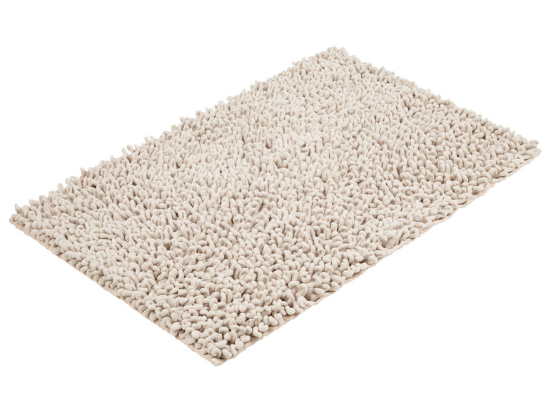 Tapis de bain beige avec une texture moelleuse.