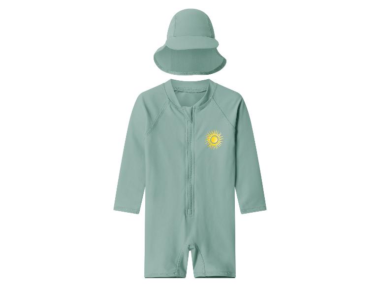 Ensemble maillot de bain bébé vert menthe à manches longues, fermeture éclair et imprimé soleil, avec chapeau assorti.
