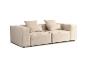 Canapé modulaire beige avec coussins sur fond blanc.