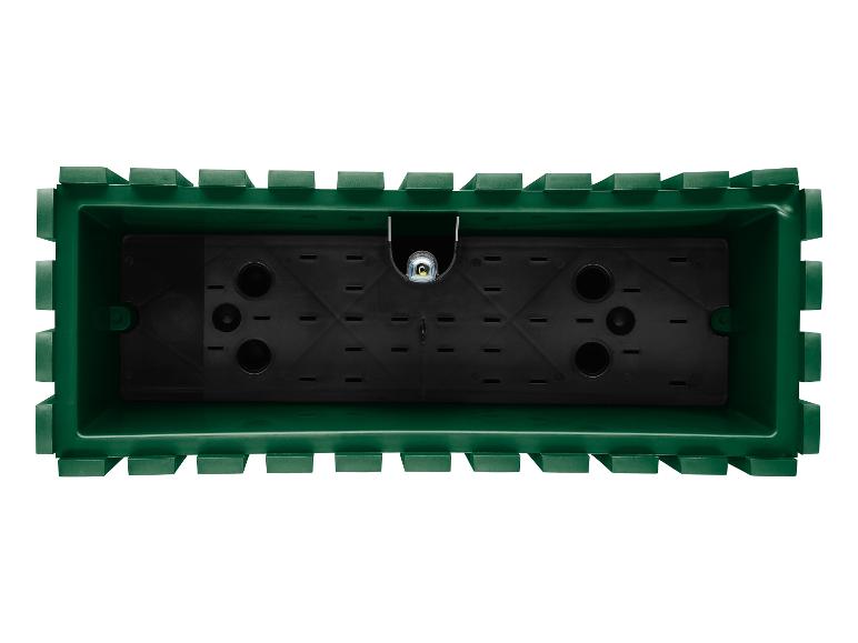 Un pot de fleurs vert avec des trous de drainage.