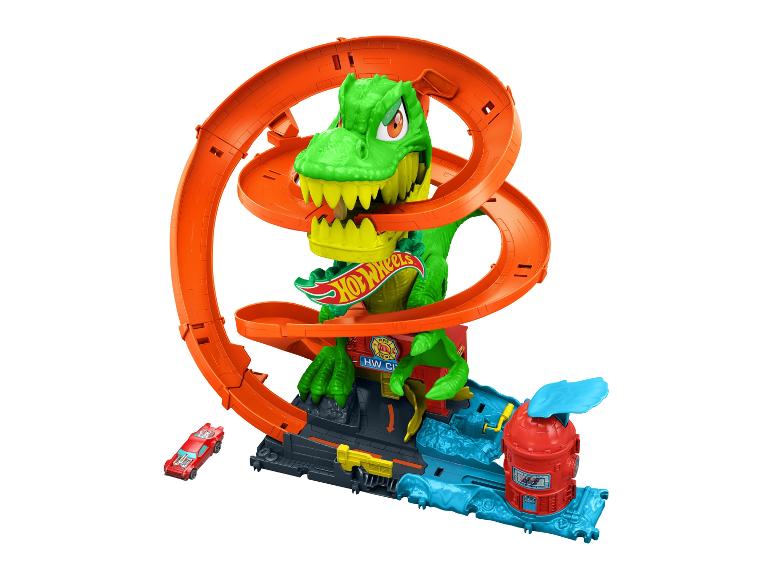 Ensemble de jeu Hot Wheels avec un dinosaure vert et une piste orange.