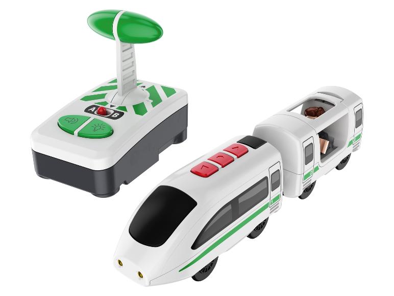 Un train jouet avec wagon et télécommande