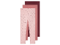 Trois leggings pour filles dans des tons rose et bordeaux.