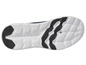 La semelle blanche d'une sneaker bleue avec un motif en nid d'abeille.