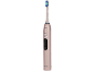 Brosse à dents électrique rose avec poils bleus et verts, avec bouton marche/arrêt.