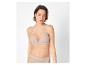 Femme en soutien-gorge et culotte beiges, regardant droit devant.