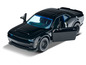 Une voiture jouet Dodge Challenger noire avec une porte ouverte.