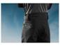Pantalon noir avec ceinture sur un fond de ciel bleu.