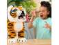 Une fille rugit aux côtés d'un tigre en peluche interactif.