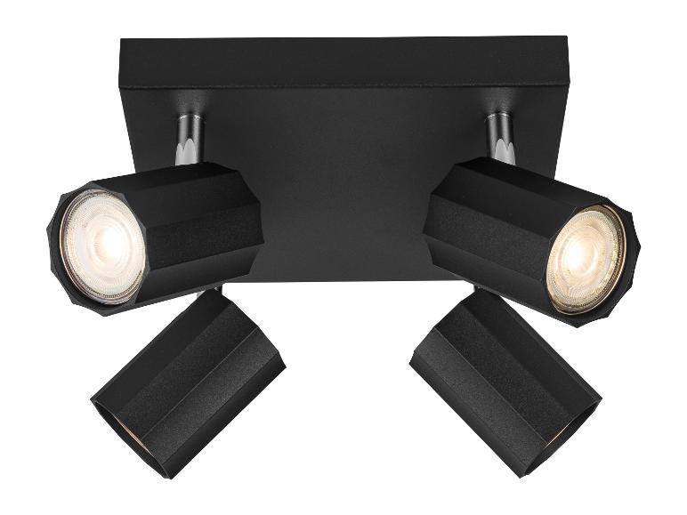 Plafonnier noir avec quatre spots.
