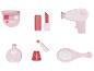 Sèche-cheveux rose, brosse à cheveux, maquillage et parfum.