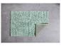 Tapis de bain vert pastel texturé.