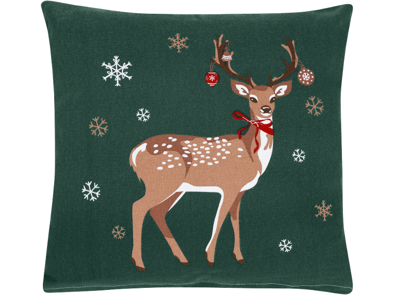 Coussin vert avec une image de cerf, des flocons de neige et des décorations de Noël.
