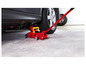 Un cric de voiture rouge sous une voiture dans un garage.