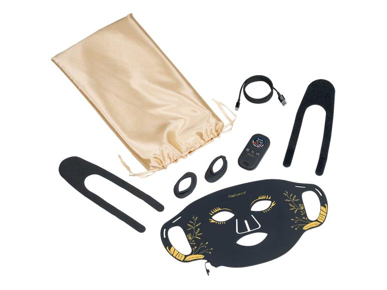 Masque facial de beauté noir avec détails dorés, télécommande et accessoires.