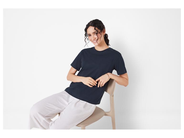 T-shirt foncé et pantalon blanc ample : vêtements décontractés.
