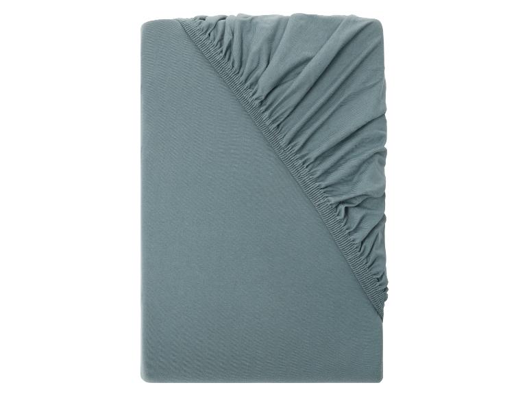 Drap-housse sarcelle avec élastique froncé.