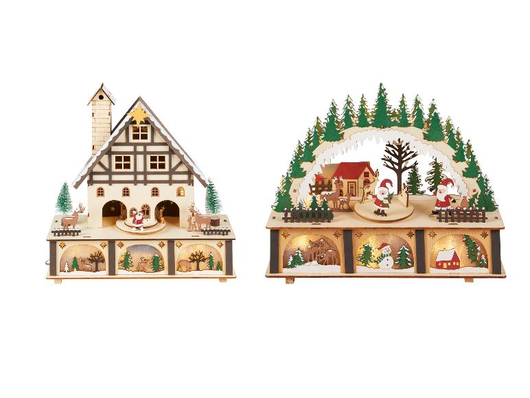 Deux décorations musicales de Noël en bois avec lumières et figurines.