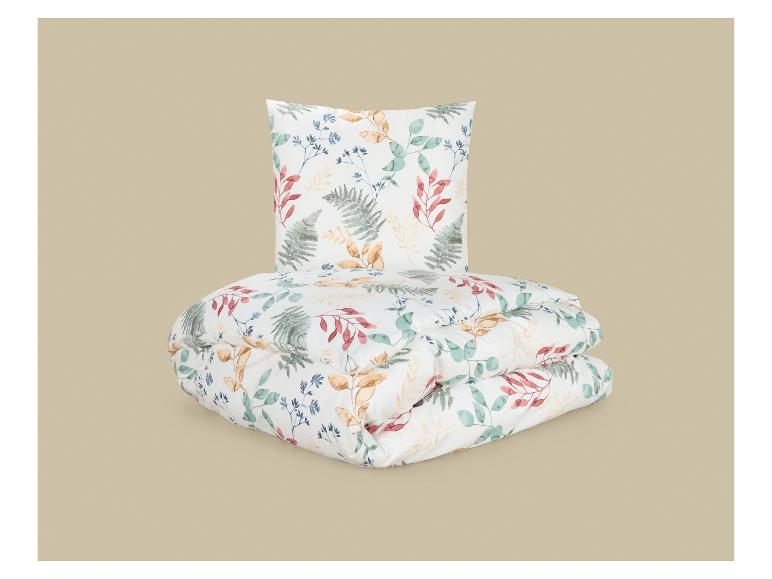 Ensemble couette et oreiller à motif de feuilles colorées.