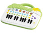Un piano jouet vert avec des motifs d'animaux et des touches.