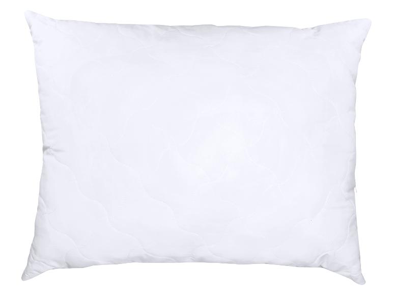 Oreiller blanc matelassé avec un motif ondulé