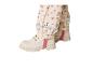 Bottes crème et pantalon à motifs floraux avec bandes réfléchissantes.