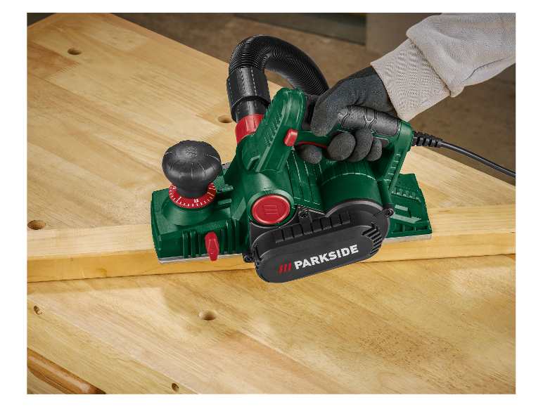 Un menuisier utilise une raboteuse Parkside pour travailler le bois.