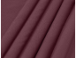 Gros plan d'un tissu bordeaux avec de légers plis.