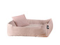 Un lit pour chien rose avec un coussin