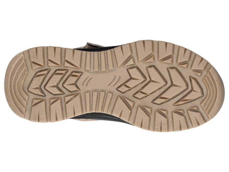 Semelle extérieure d'une chaussure de randonnée marron et noire avec un motif robuste