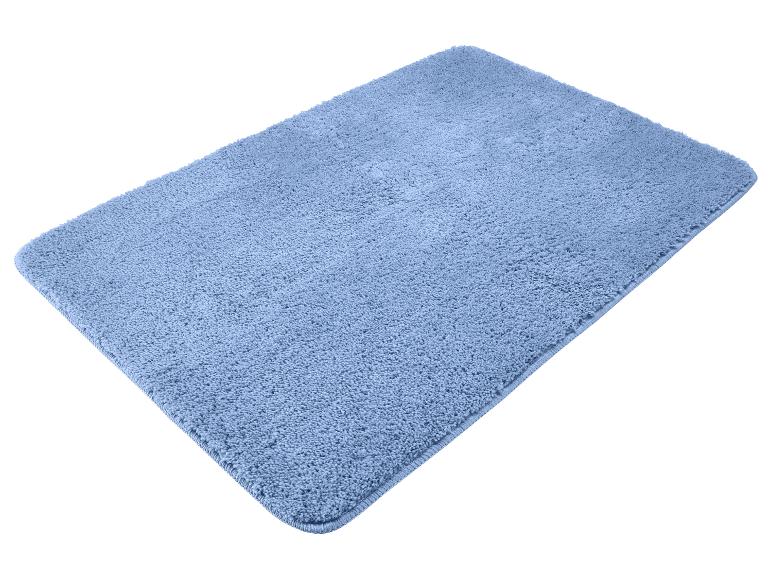 Tapis de bain bleu à texture douce sur fond blanc.