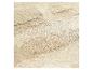 Gros plan d'une surface texturée beige clair avec de subtiles veines brunes, ressemblant à de la pierre naturelle.