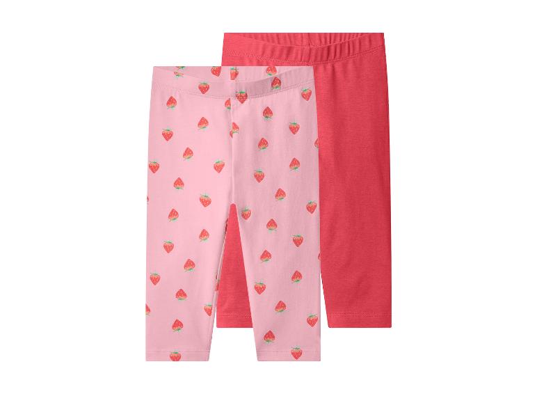 Deux paires de leggings pour enfants : un rose à motif fraises et un rouge uni.