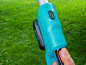 Une débroussailleuse sans fil Gardena bleue avec une batterie pleine.