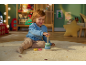 Enfant heureux jouant avec un jouet d'empilement en bois sur un tapis dans une chambre d'enfant.
