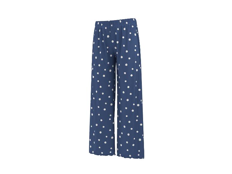 Pantalon bleu à motif marguerites.
