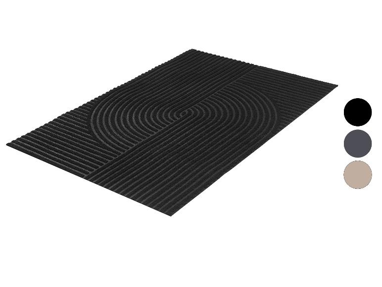 Paillasson rectangulaire noir avec un motif géométrique de lignes et de demi-cercles.