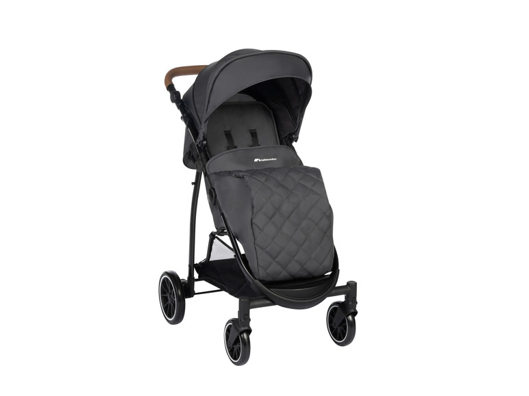 Une poussette Babycomfort noire avec un rembourrage matelassé.