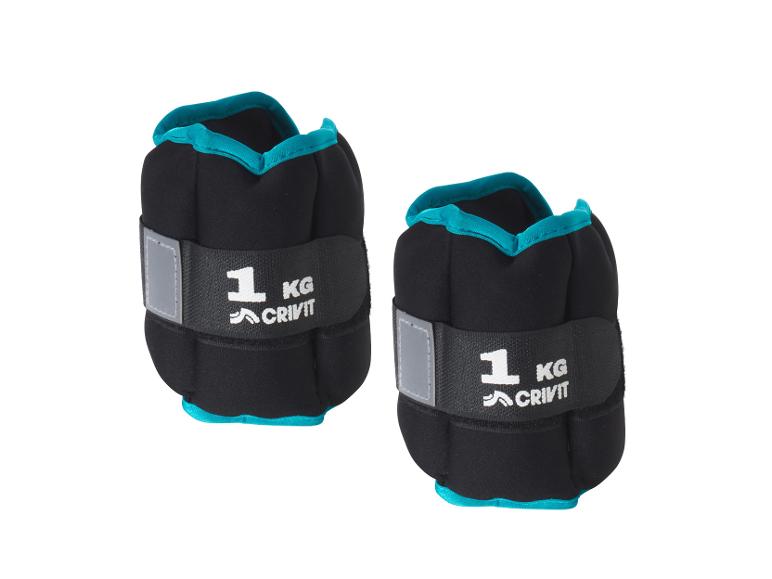 Deux poids de cheville Crivit de 1 kg bleus.