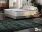 Un matelas avec un sommier et un tapis dans une chambre à coucher.