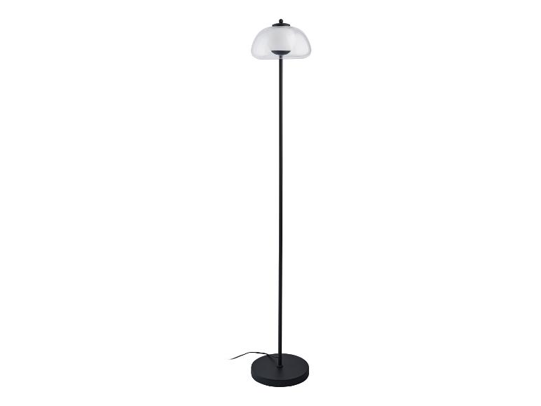 Lampadaire moderne avec abat-jour en verre transparent.
