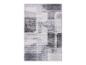 Tapis moderne gris et blanc avec motif géométrique abstrait.