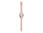 Une montre rose avec un motif floral sur le cadran.
