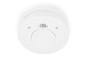 Détecteur de fumée blanc avec bouton test/silence et instructions de rotation.